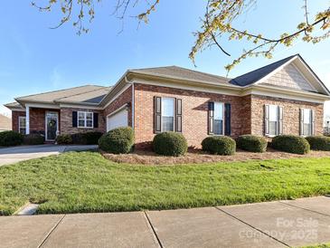 Charming brick home with manicured lawn, black shutters, and inviting curb appeal on a sunny day at 2802 Santiago Cir, Monroe, NC 28110