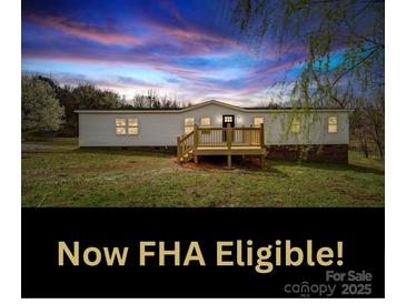 Charming single-story home features a cozy front porch and picturesque sunset views at 35494 Dry Rd, Albemarle, NC 28001