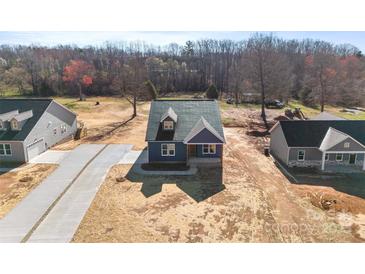 New construction home with a paved driveway, landscaped yard, and craftsman style details at 4005 Miller Rd, Salisbury, NC 28147