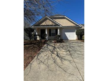 Charming single-story home with inviting front porch and well-maintained landscaping at 5009 Oak Pasture Ln, Charlotte, NC 28269