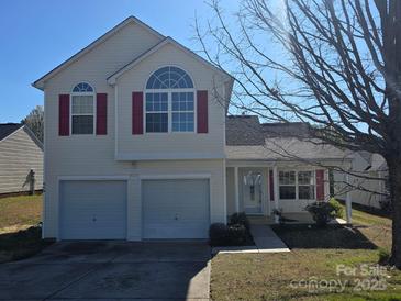 Inviting two-story home featuring a two-car garage, red shutters, and a well-maintained front lawn at 649 Favorwood Dr, Rock Hill, SC 29730