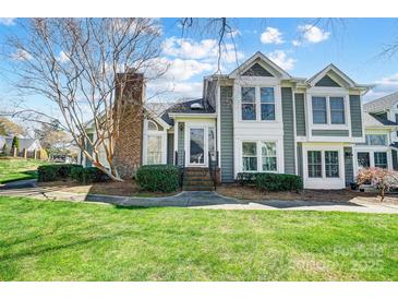 Charming townhouse with well-maintained landscaping and a brick chimney at 8250 Tradd Ct, Charlotte, NC 28210