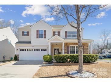 Charming two-story home with a well-manicured lawn and attached two-car garage at 12502 Bending Branch Rd, Charlotte, NC 28227