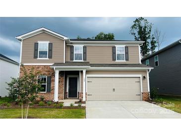 Charming two-story home features a two-car garage, brick accents, and manicured landscaping at 142 Shepherds Landing Dr, Mooresville, NC 28115