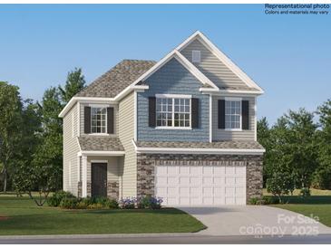 Two-story home with a stone veneer, light blue shingles and a two-car garage for a striking facade at 1816 Otter Perch Ln, Fort Mill, SC 29715