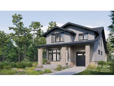 Attractive two-story home featuring stone pillars, a single car garage and a well-manicured lawn at 2555A Hemphill St, Charlotte, NC 28208