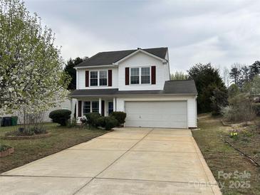 Charming two-story home featuring a large concrete driveway and attached two-car garage at 4904 Cornelia Dr, Charlotte, NC 28269