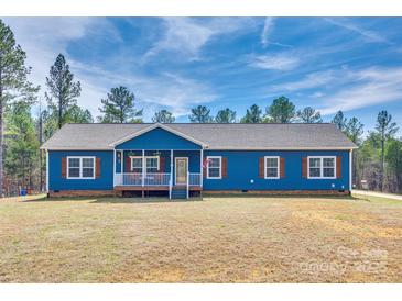 Charming blue home with a welcoming front porch, wood shutters, and well-maintained lawn at 1370 Martin Rd, Hickory Grove, SC 29717