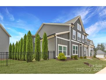 Gray townhouse showcasing modern architectural design and manicured landscaping in a desirable community at 11327 James Coy Rd, Davidson, NC 28036