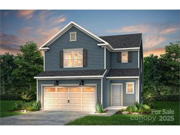 Charming two-story home featuring a welcoming two car garage and beautifully designed exterior at 13014 Garren View Ln # 306, Charlotte, NC 28278