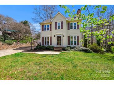 Charming two-story home featuring a well-maintained lawn and traditional architectural details on a sunny day at 207 Crossing Ave, Belmont, NC 28012