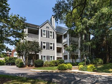 Attractive multi-story condo with multiple balconies and well-maintained landscaping and yard at 2310 Roswell Ave # H, Charlotte, NC 28207