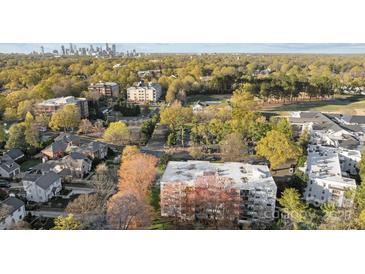 Stunning aerial view of the property surrounded by lush greenery and city skyline at 2503 Roswell Ave # 208, Charlotte, NC 28209