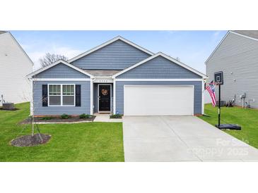 Charming single-story home with blue siding, a two-car garage, manicured lawn, and welcoming front entrance at 2766 Sherrills Stream Dr, Sherrills Ford, NC 28673