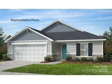 Charming single-story home with a two-car garage, stone accents, light gray siding, and a well-manicured lawn at 313 Maidstone Dr # 58, Monroe, NC 28110