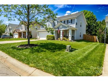 Charming two-story home with beautiful lawn, landscaping, and an attached two-car garage at 513 Buttercup Way, Fort Mill, SC 29715