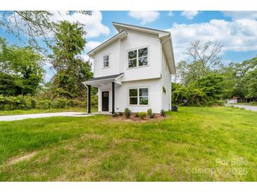 Charming two-story home featuring a crisp white exterior, black accents, and a well-manicured lawn at 600 Legrand St, Shelby, NC 28150