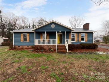 Charming single-story home features a welcoming front porch, shutters, and a beautifully maintained lawn at 1125 Twin Lakes Rd, Rock Hill, SC 29732