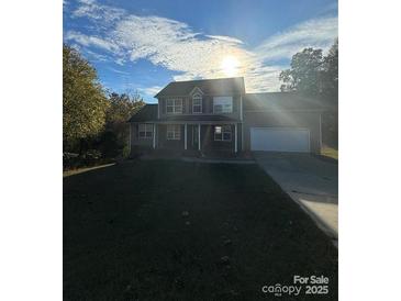 Charming two-story home with a manicured front lawn, attached garage, and inviting front porch at 125 Blue Sky Cir, Shelby, NC 28152