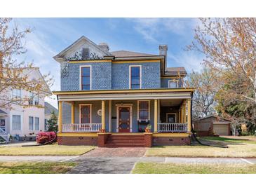 Charming two-story home with a welcoming front porch and detailed architectural features in a residential neighborhood at 143 Reid St, Rock Hill, SC 29730