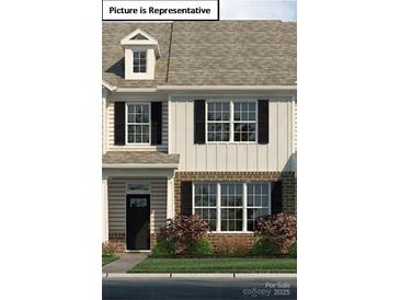 Charming two-story townhome featuring black shutters and a well-maintained landscaped front yard at 2056 Harlequin Dr, Indian Trail, NC 28079