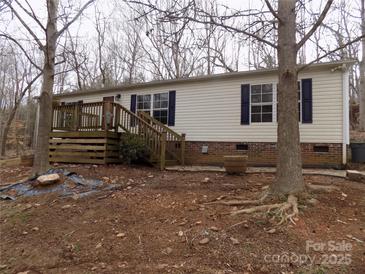 Charming mobile home features a wooden deck, brick foundation, and classic shutters at 2130 Babbling Brook Ln, Gastonia, NC 28052