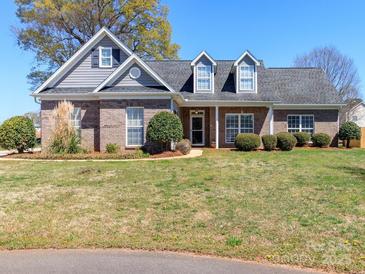 Charming single-story brick home featuring a well-manicured lawn, dormers and a welcoming entrance at 3816 Sonoma Way, Monroe, NC 28110
