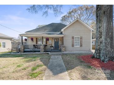 Charming single-story home with a welcoming front porch and cozy curb appeal with colorful decor at 41 Selma Dr, Mooresville, NC 28115