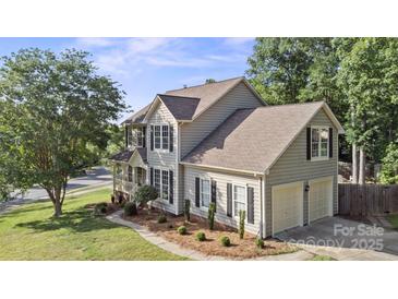Charming two-story home featuring a two-car garage and manicured lawn with tasteful landscaping at 6210 Skyline Dr, Charlotte, NC 28269