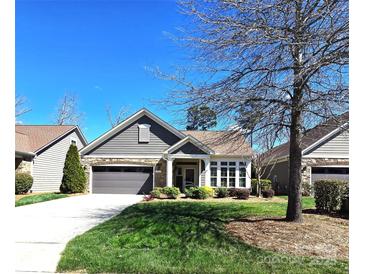 Charming home featuring stone accents, well-maintained landscaping, a driveway, and an attached two-car garage at 1112 Avalon Pl, Stallings, NC 28104