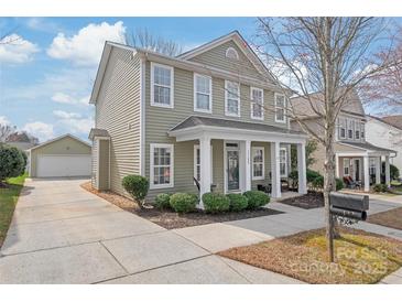 Charming two-story home with a detached garage and a cozy front porch at 11122 Aprilia Ln, Cornelius, NC 28031