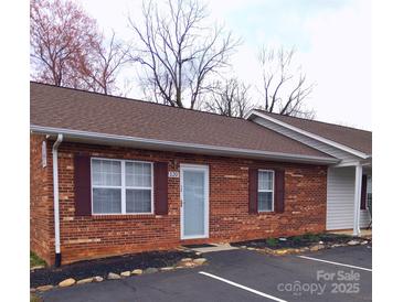 Charming brick house featuring a well-maintained lawn and a clean, inviting facade at 120 24Th Street St, Hickory, NC 28601