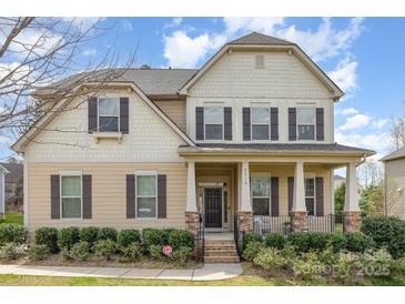 Charming two-story home featuring a welcoming porch and well-manicured landscaping at 2110 Capricorn Ave, Indian Trail, NC 28079