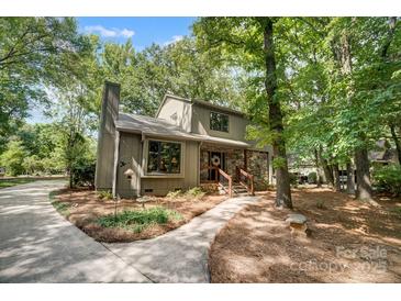 Charming home with stone accents, well-maintained landscaping, and mature trees at 4124 Woodfox Dr, Charlotte, NC 28277