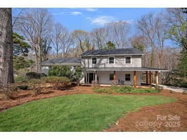 Charming two-story home with a welcoming front porch and landscaped front yard at 7214 Benita Dr, Charlotte, NC 28212