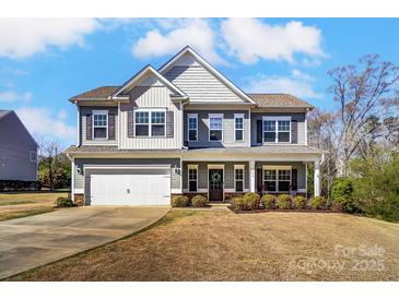 Charming two-story home with a well-maintained front yard, covered porch, and attached two-car garage at 100 Marabou Ct, Mount Holly, NC 28120