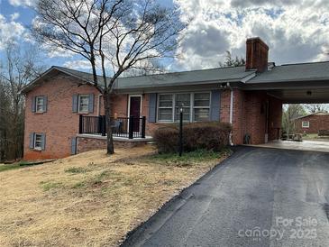 Exterior home shot featuring a front porch and covered parking area with paved driveway at 356 Lucky Hollow Rd, Hickory, NC 28601