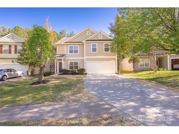 Two-story home with a well-manicured lawn, a two-car garage, and a long concrete driveway at 4528 Potters Glen Rd, Charlotte, NC 28269