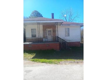 Modest single-story home with a small porch and railing at 544 3Rd St, Chester, SC 29706