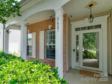Charming covered front porch with brick facade and white columns at 9607 Kestral Ridge Dr, Charlotte, NC 28269