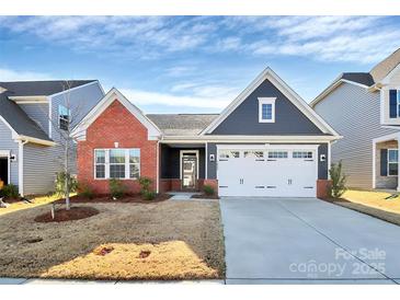 Charming single Gathering home with a two car garage, manicured lawn, and traditional architectural details at 1032 Barnette Farm Ln, Monroe, NC 28110