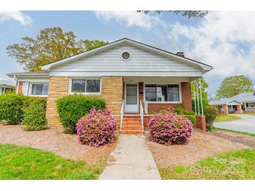Charming brick home with blooming azaleas and well-maintained front yard landscaping at 1400 Russell Ave, Charlotte, NC 28216