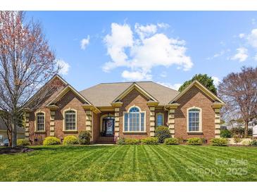 Charming brick home featuring manicured lawn, symmetrical design, and inviting entrance at 2508 Shaggy Bark Ct, Belmont, NC 28012