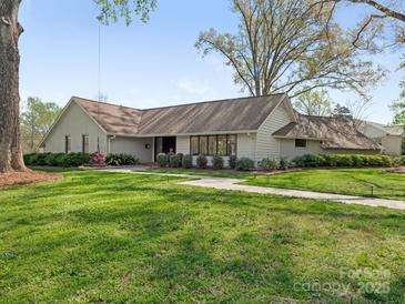 Lovely single story home with a long yard and mature landscaping at 3301 Mountainbrook Rd, Charlotte, NC 28210