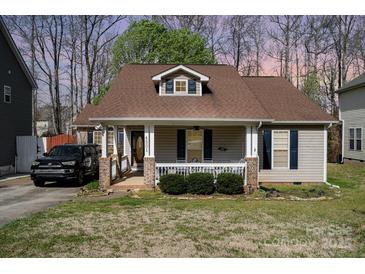 Charming single-story home featuring a welcoming front porch, tan siding, and well-maintained landscaping at 4501 Brandie Glen Rd, Charlotte, NC 28269