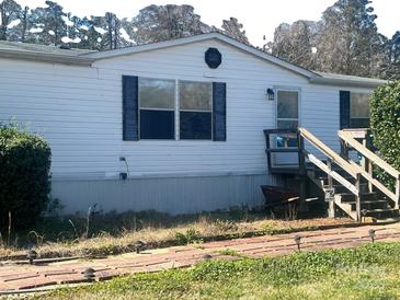 Charming single-Gathering home with inviting front entrance and a well-manicured front yard at 5320 Golden Pond Dr, York, SC 29745