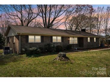 Charming brick home with well-kept lawn and mature trees, perfect for suburban living at 839 Oak Grove Rd, Kings Mountain, NC 28086