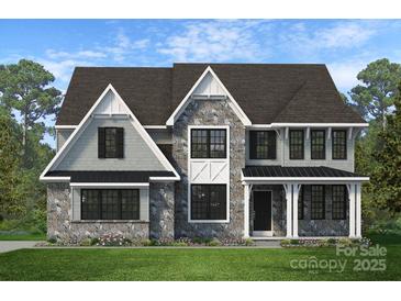 Charming two-story home with stone accents, black trim and shutters, and a welcoming front porch, all nestled on a green lawn at Lot 14 Mayes Meadow Dr, Cornelius, NC 28078