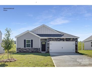 Charming single-Gathering home with stone accents, a well-manicured lawn, and a two-car garage at 112 Parker Claire Ln, Kings Mountain, NC 28086