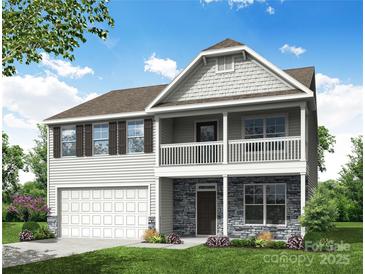 Charming two-story home with stone accents, white siding, a two-car garage, and inviting front porch and balcony at 1440 Ardmore Dr # 343, Sherrills Ford, NC 28673